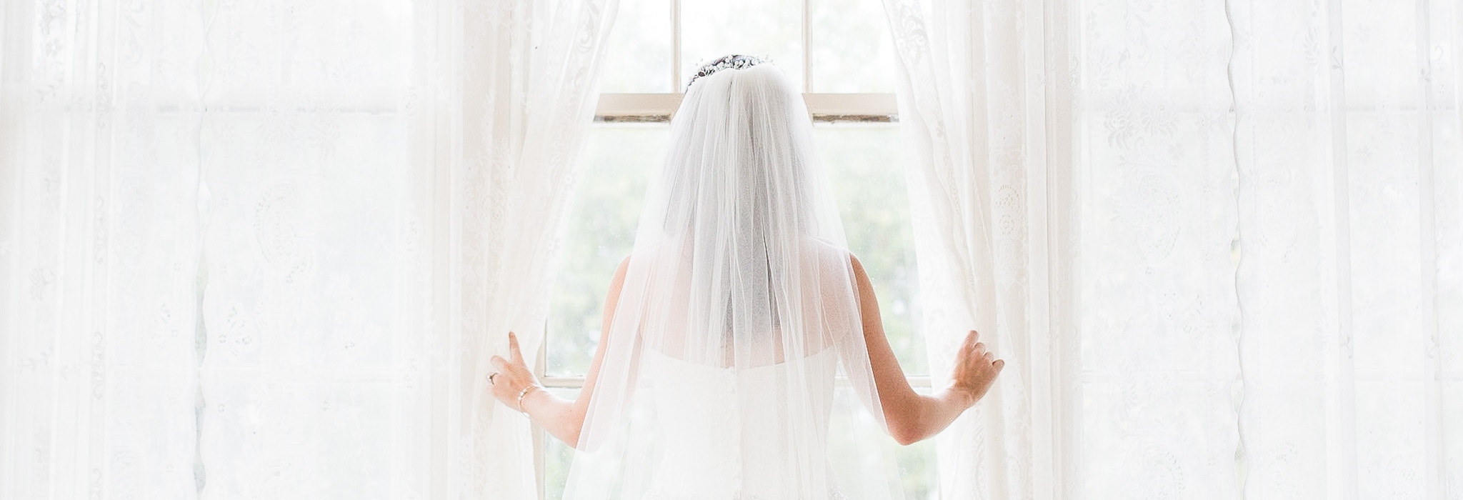 Bride looking out window